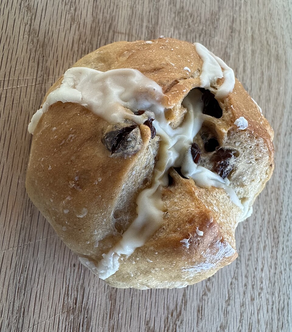 The Hot Cross — a hot cross bun with icing pooling in the scored grooves